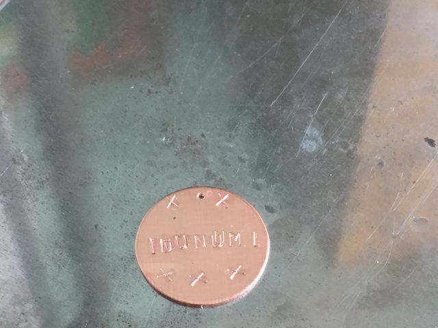 A finished stamped metal disc