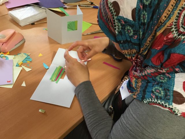 Refugee Action client trying Iris paper folding technique