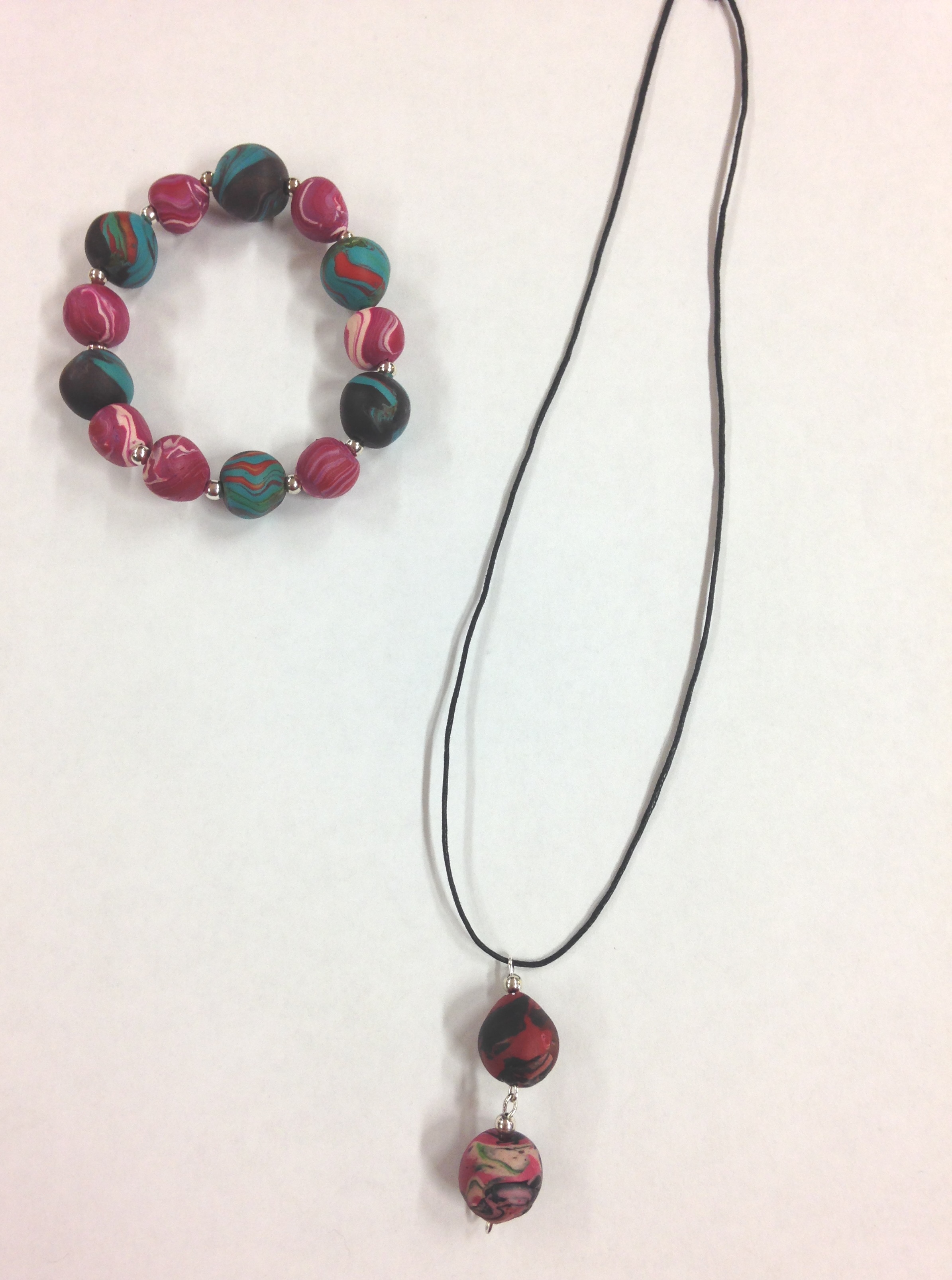 necklace with two balls and a necklace with alternating pink/ white and blue/ black pearls