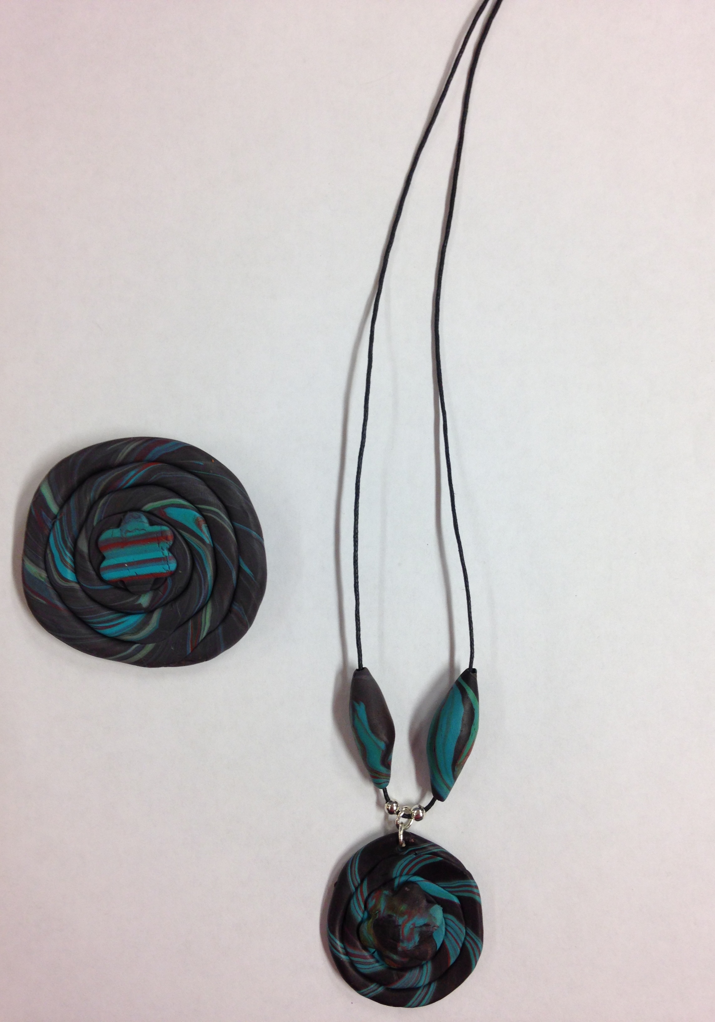 Brooch and necklace made from a mixture of black and blue