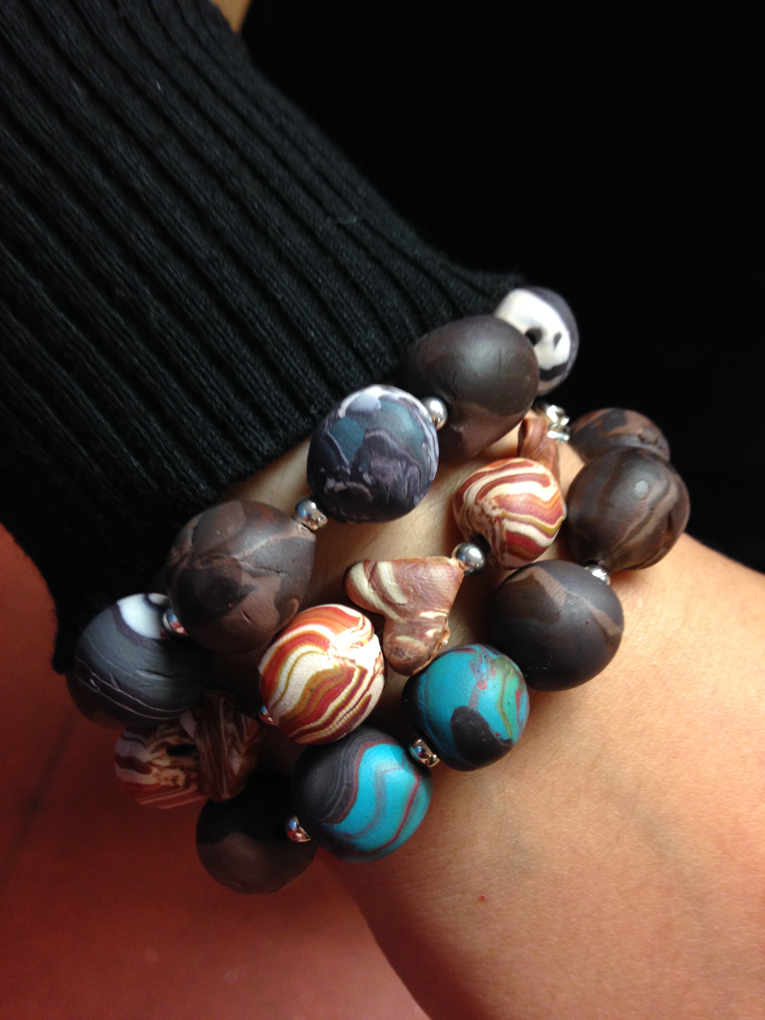 three beautiful pieces of polymer clay jewellery in brown tones.