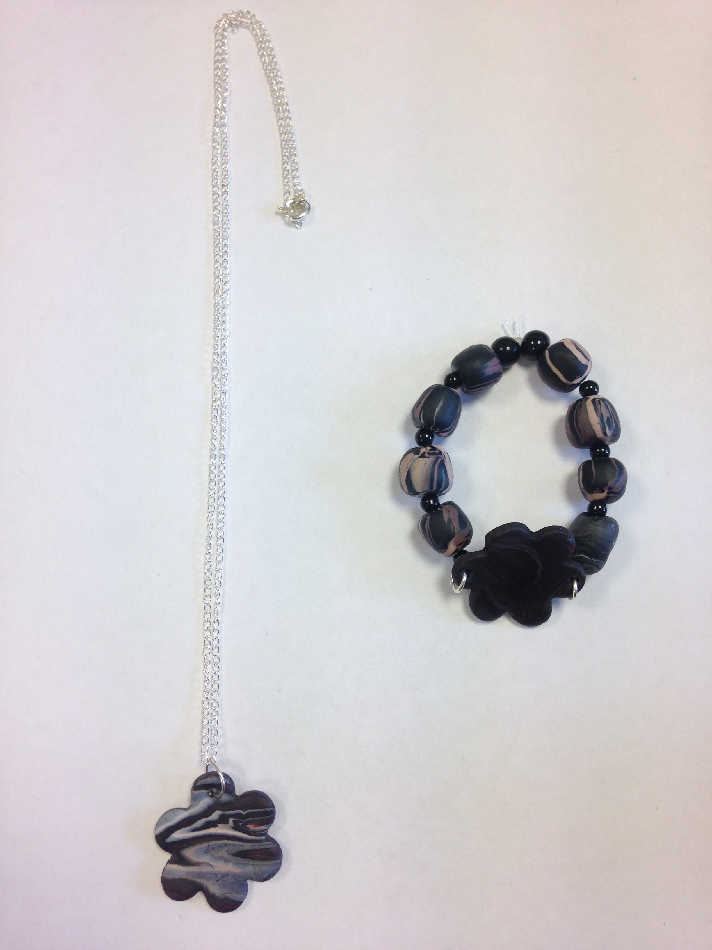 necklace and bracelet with a black flower