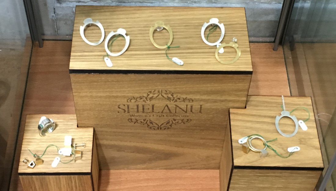 silver jewellery collection 'interlocking stories' displayed on wooden stands